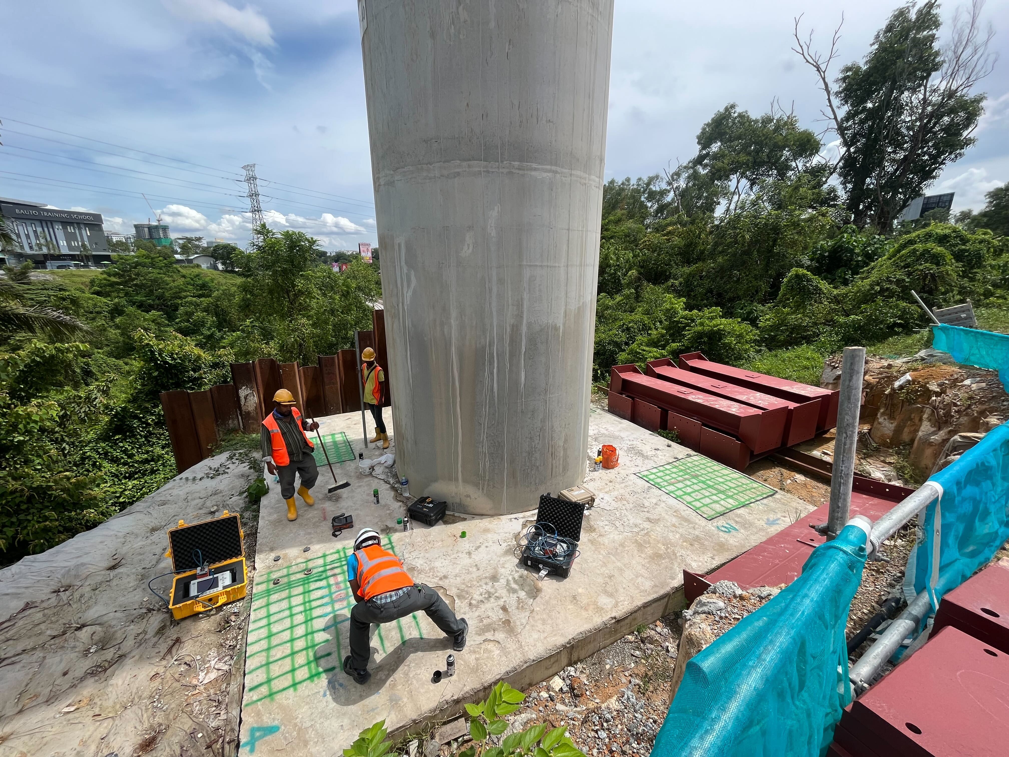 Xradar Asia technicians scan and mark a concrete slab at the foot of a pillar